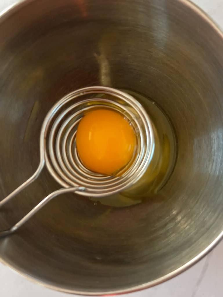 separating the eggs into a bowl.