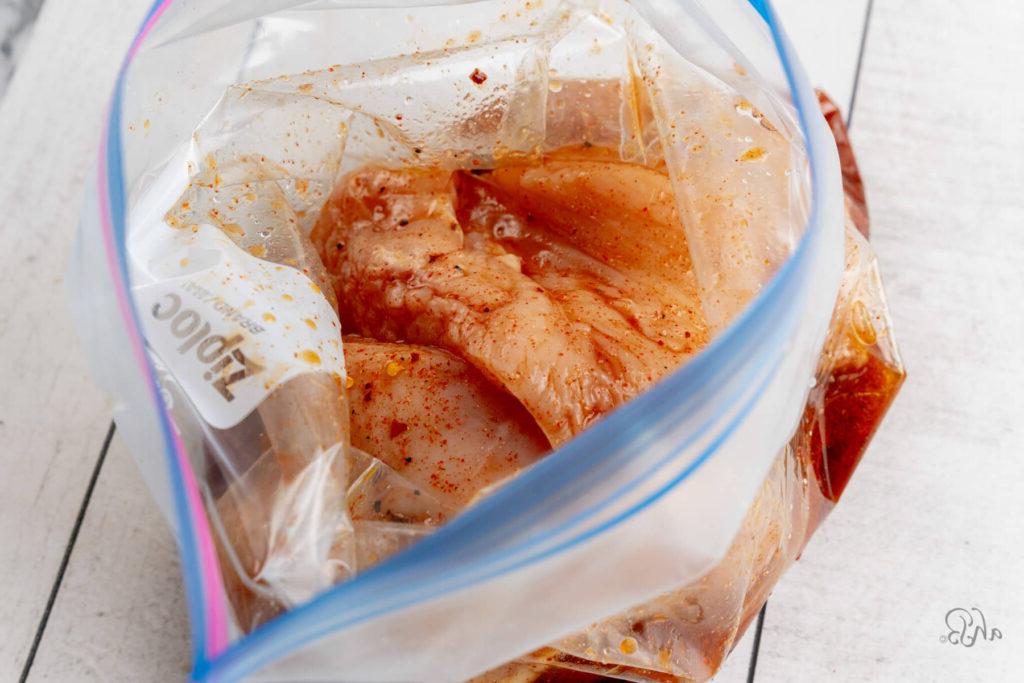 The chicken breasts are in a Ziploc bag with the marinade mixture.