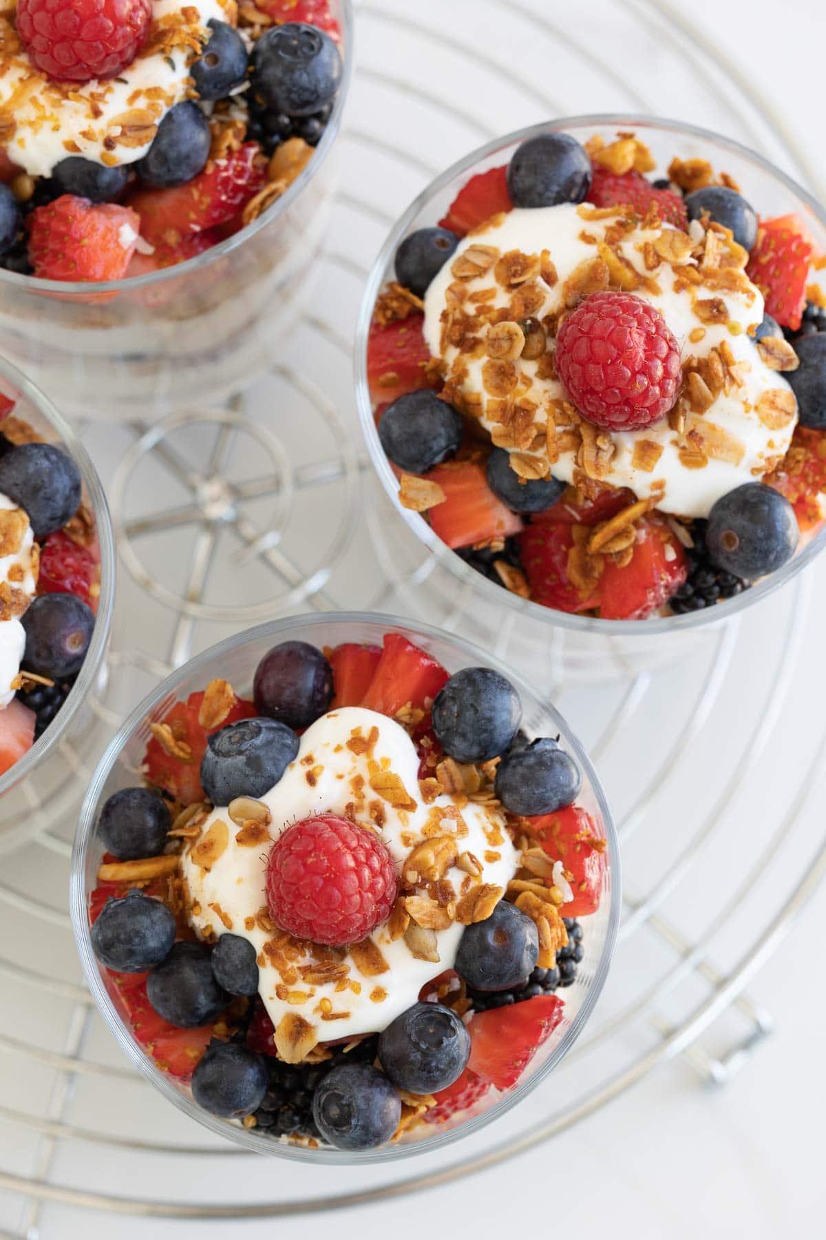 Colorful yogurt and fruit parfaits, top down view with granola.